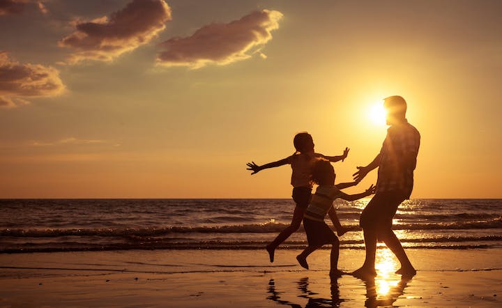 Father,And,Children,Playing,On,The,Beach,At,The,Sunset